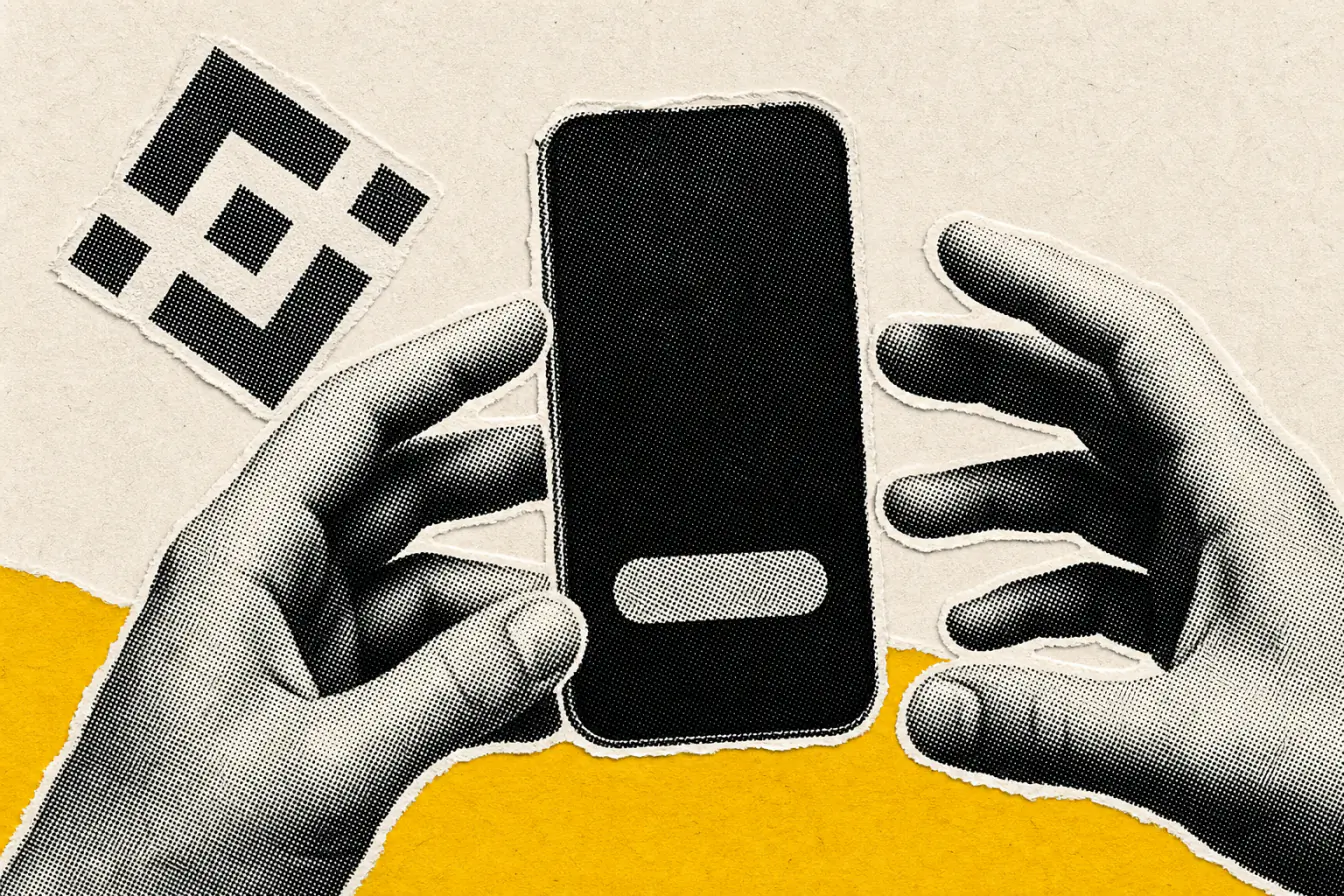 Des mains encadrent un téléphone Binance
